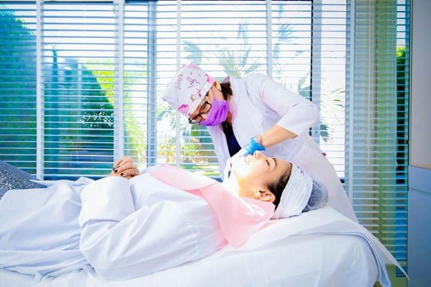 The doctor is contouring the patient’s jawline with Dermal Fillers